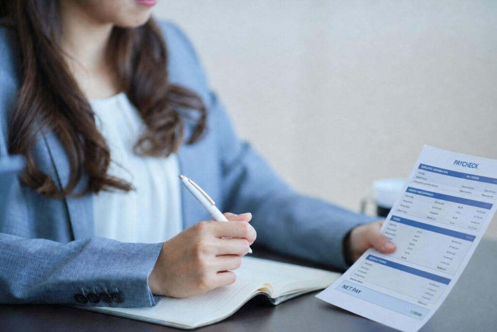 Salaried employee reviewing a paycheck to determine whether overtime pay was included under FLSA rules.