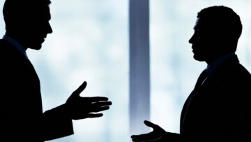 Franchisees and a franchisor reviewing agreement terms during a franchise dispute