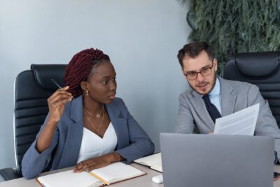 Two professionals negotiating garden leave agreement terms before the signing deadline
